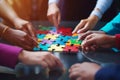Concept of teamwork and partnership. Hands join puzzle pieces in the office. business people putting the jigsaws team Royalty Free Stock Photo