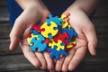 Concept of teamwork and problem-solving with a man holding colorful jigsaw puzzle pieces Royalty Free Stock Photo