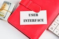 The concept of technology and development. Phrase, word, text USER INTERFACE on a white business card on the background