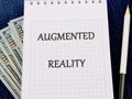 The concept of technology and development. Phrase, words, text AUGMENTED REALITY on a blank sheet of notepad Royalty Free Stock Photo