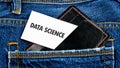 The concept of technology and development. Phrase, words, text DATA SCIENCE on a business card from against the