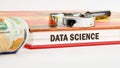 The concept of technology and development. Phrase, words, text DATA SCIENCE on the end of the book, front view