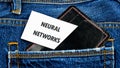 The concept of technology and development. Phrase, words, text NEURAL NETWORKS on a business card from against the