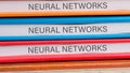 The concept of technology and development. Phrase, words, text NEURAL NETWORKS close-up on the ends of the notebooks
