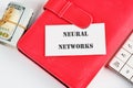 The concept of technology and development. Phrase, words, text NEURAL NETWORKS on a white business card on the