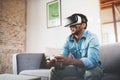 Concept of technology,gaming,entertainment and people.Happy african man enjoying virtual reality glasses while relaxing Royalty Free Stock Photo