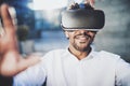 Concept of technology,gaming,entertainment and young people.Smiling american african man enjoying virtual reality