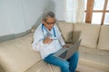 Concept of telehealth: a doctor in front of a computer and talking to a patient