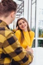 Young man in love touching tenderly his girlfriend`s hair, holding her hand, she looks really happy. Royalty Free Stock Photo