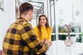 Young man in love touching tenderly his girlfriend`s hair, holding her hand, she looks really happy. Royalty Free Stock Photo