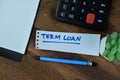 Concept of Term Loan write on sticky notes isolated on Wooden Table