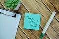 Concept of Thank You write on sticky notes isolated on Wooden Table Royalty Free Stock Photo