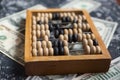 Concept on the theme of the financial crisis. Close-up Dollars on which lie wooden old abacus. Selective focus Royalty Free Stock Photo