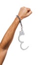 Concept on the theme of freedom. Male handcuffed hand raised up isolated