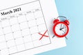 Concept for time change for daylight saving summer time in Europe on March 28th with red alarm clock and calendar sheet Royalty Free Stock Photo