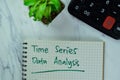 Concept of Time Series Data Analysis write on a book with statistics isolated on Wooden Table