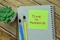 Concept of Time to Modernize write on sticky notes isolated on Wooden Table