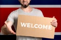 The concept of tolerance for immigrants and people of different life positions. A man holds a cardboard and stretches out his hand