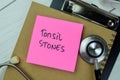 Concept of Tonsil Stones write on sticky notes isolated on Wooden Table