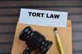 Concept of Tort Law write on paperwork with gavel isolated on wooden background