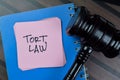 Concept of Tort Law write on sticky with gavel notes isolated on Wooden Table
