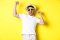 Concept of tourism and lifestyle. Happy lucky guy winning trip, rejoicing and wearing holiday outfit, summer hat and Royalty Free Stock Photo