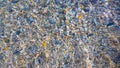 Concept of tranquility, Transparent sea water in the beach, with stones in the background.