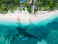 The concept of travel and air travel. Top view of the ocean coast, with the shadow on the water from the plane taking off. Copy Royalty Free Stock Photo