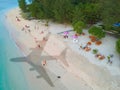 The concept of travel and air travel. Top view of the sandy ocean coast with people, with the shadow on the water from the plane Royalty Free Stock Photo