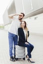 Concept of travel, airplane flights. Man and woman with a suitcase waiting for a flight near the airport Royalty Free Stock Photo