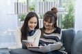 Concept of travel in summer and holiday. Two Asian woman in the living room. Relaxed young woman sitting on sofa Royalty Free Stock Photo