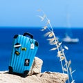 Concept travel to the sea. Stylish suitcase against the blue sea Royalty Free Stock Photo