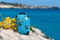 Concept travel to the sea. Stylish suitcase against the blue sea Royalty Free Stock Photo