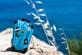 Concept travel to the sea. Stylish suitcase against the blue sea Royalty Free Stock Photo