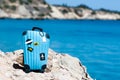 Concept travel to the sea. Stylish suitcase against the blue sea Royalty Free Stock Photo