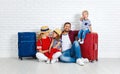 Concept travel and tourism. happy family with suitcases near w Royalty Free Stock Photo