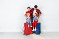 Concept travel and tourism. happy family with suitcases near w Royalty Free Stock Photo