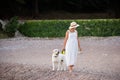 Concept of traveling with pets, pet friendly beach. Pregnant future woman with golden retriever Royalty Free Stock Photo
