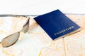 Concept of travelling, shopping, vacation, rest and relax. Selective focus on passport and sunglasses laying on map