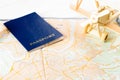 Concept of travelling, shopping, vacation, rest and relax. Selective focus on passport and wooden airplane laying on map of roads