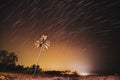 Concept Of Tropical Island. 5k . Night Starry Sky Over Tropical Beach With Lonely Palm Tree. Unusual Stars Effect Sky