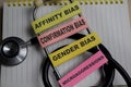 Concept of 4 types of unconscious bias. Affinity, confirmation, gender, microaggressions write on sticky notes isolated on Wooden Royalty Free Stock Photo