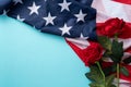 Concept of Independence day or Memorial day. American Flag over blue table background with red rose Royalty Free Stock Photo