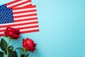 Concept of Independence day or Memorial day. American Flag over blue table background with red rose Royalty Free Stock Photo