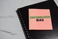 Concept of Unconscious bias write on sticky notes isolated on Wooden Table Royalty Free Stock Photo