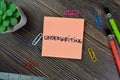 Concept of Underwriting write on sticky notes isolated on Wooden Table