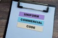 Concept of Uniform Commercial Code write on sticky notes isolated on Wooden Table Royalty Free Stock Photo