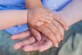 Concept of unity, support, protection, happiness. Child hand closeup into parents. Hands of father, mother, keep hand little baby Royalty Free Stock Photo