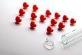 Abriveura IVF from red hearts and a broken test tube in the foreground. Concept of unsuccessful in vitro fertilization. The theme Royalty Free Stock Photo