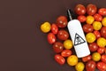 Concept for usage of dangerous pesticides in agricultural food products with tomatoes and spray bottle with warning label